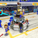 Image for article titled Pit Crew Panic – Girls in Miniskirts Fixing Giant Toilets